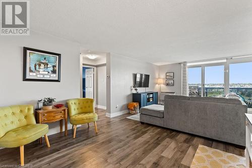 Living room with dark hardwood / wood-style flooring and a textured ceiling - 9 Bonheur Court Unit# 802, Brantford, ON 