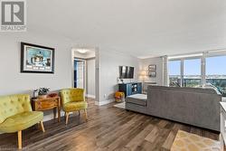 Living room with dark hardwood / wood-style flooring and a textured ceiling - 