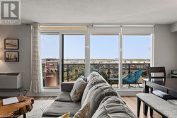 Living room with plenty of natural light and light hardwood / wood-style flooring - 