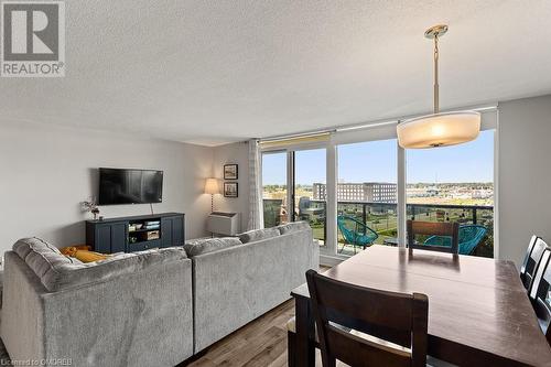 Living room featuring a textured ceiling and hardwood / wood-style flooring - 9 Bonheur Court Unit# 802, Brantford, ON 