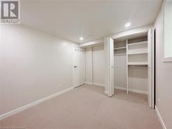 Unfurnished bedroom with light colored carpet and a closet - 