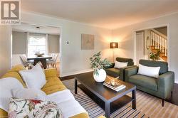 Living room with hardwood / wood-style flooring and ornamental molding - 