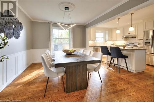 Dining space with hardwood / wood-style flooring and crown molding - 147 Dalewood Drive, Kitchener, ON 