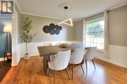 Dining area featuring light hardwood / wood-style flooring and ornamental molding - 