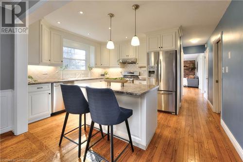 Kitchen with white cabinets, a center island, stainless steel appliances, and light hardwood / wood-style flooring - 147 Dalewood Drive, Kitchener, ON 