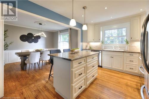 Kitchen with hanging light fixtures, a kitchen island, light hardwood / wood-style floors, and appliances with stainless steel finishes - 147 Dalewood Drive, Kitchener, ON 