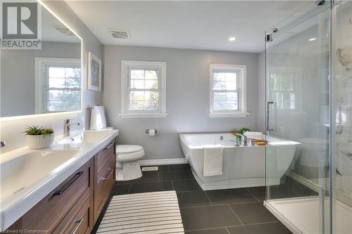 Full bathroom featuring tile patterned flooring, vanity, a healthy amount of sunlight, and shower with separate bathtub - 147 Dalewood Drive, Kitchener, ON 