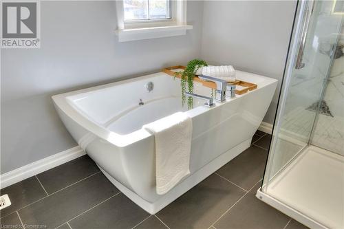 Bathroom featuring tile patterned flooring and shower with separate bathtub - 147 Dalewood Drive, Kitchener, ON 