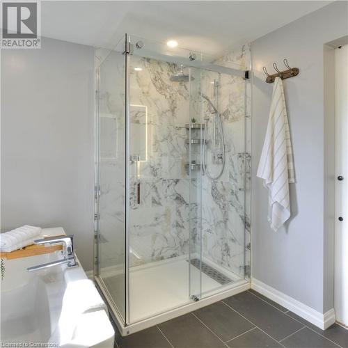 Bathroom featuring tile patterned flooring and a shower with door - 147 Dalewood Drive, Kitchener, ON 