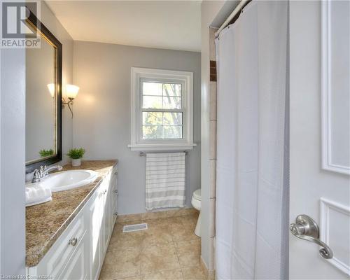 Bathroom with tile patterned flooring, vanity, and toilet - 147 Dalewood Drive, Kitchener, ON 