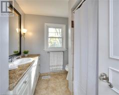 Bathroom with tile patterned flooring, vanity, and toilet - 