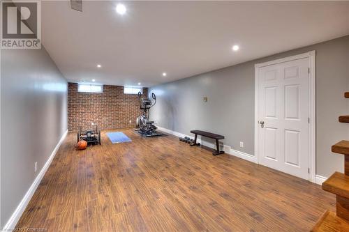 Workout area featuring hardwood / wood-style floors and brick wall - 147 Dalewood Drive, Kitchener, ON 