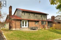 Rear view of property featuring a patio area and a yard - 