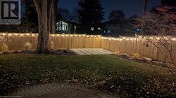 Yard at night featuring a patio - 