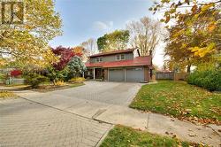 View of property featuring a garage and a front yard - 