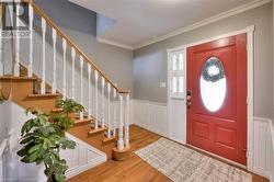 Entrance foyer featuring crown molding, a healthy amount of sunlight, and light wood-type flooring - 