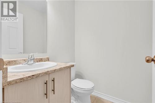 Bathroom featuring tile patterned floors, vanity, and toilet - 677 Park Road N Unit# 147, Brantford, ON 