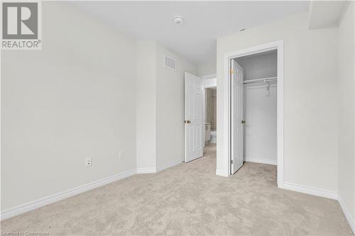 Unfurnished bedroom featuring a closet and light colored carpet - 677 Park Road N Unit# 147, Brantford, ON 