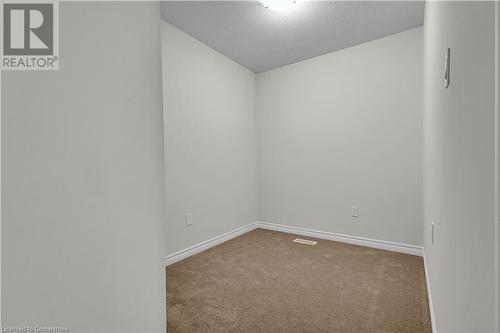 Carpeted spare room featuring a textured ceiling - 677 Park Road N Unit# 147, Brantford, ON 