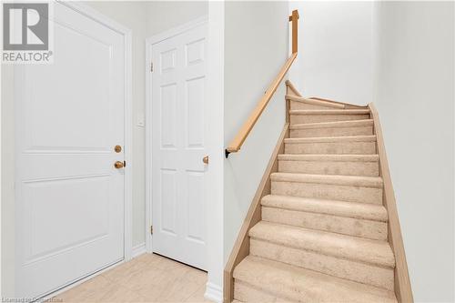 Stairway featuring tile patterned floors - 677 Park Road N Unit# 147, Brantford, ON 