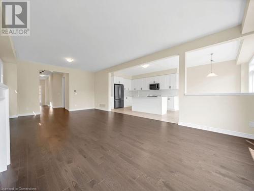 Unfurnished living room featuring dark wood-type flooring - 126 Broadacre Drive, Kitchener, ON 