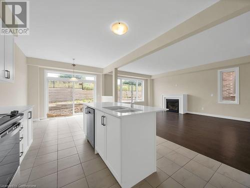 Kitchen featuring white cabinetry, sink, stainless steel appliances, a center island with sink, and light wood-type flooring - 126 Broadacre Drive, Kitchener, ON 