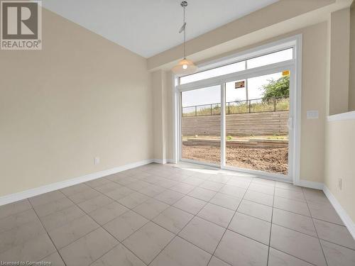 Unfurnished dining area with a wealth of natural light and light tile patterned floors - 126 Broadacre Drive, Kitchener, ON 