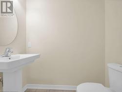 Bathroom with sink, tile patterned flooring, and toilet - 