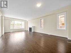 Unfurnished living room featuring dark wood-type flooring - 