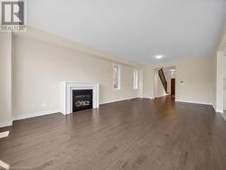 Unfurnished living room with dark wood-type flooring - 