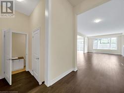 Hallway with dark hardwood / wood-style flooring - 