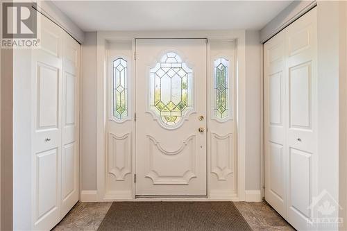 Front entrance, featuring two coat closets and porcelain tile flooring - 10 Riverbrook Road, Ottawa, ON 