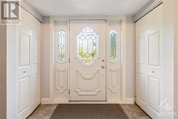 Front entrance, featuring two coat closets and porcelain tile flooring - 