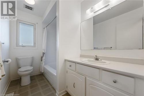 Full bathroom with vanity, toilet, and shower / bath combo with shower curtain - 118 Oak Street, Simcoe, ON 