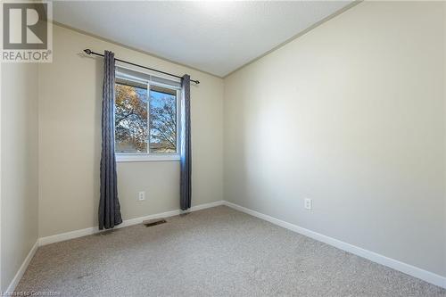 Carpeted spare room with lofted ceiling and a textured ceiling - 118 Oak Street, Simcoe, ON 