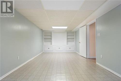 Empty room with built in shelves and a paneled ceiling - 118 Oak Street, Simcoe, ON 