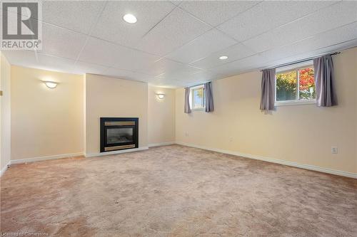 Basement with carpet flooring, a drop ceiling, and a healthy amount of sunlight - 118 Oak Street, Simcoe, ON 