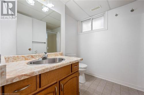 Bathroom featuring toilet, vanity, and walk in shower - 118 Oak Street, Simcoe, ON 