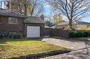 View of home's exterior with a garage and a lawn - 118 Oak Street, Simcoe, ON 