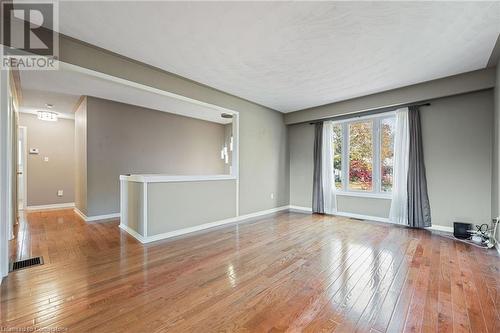 Unfurnished room featuring light hardwood / wood-style floors - 118 Oak Street, Simcoe, ON 