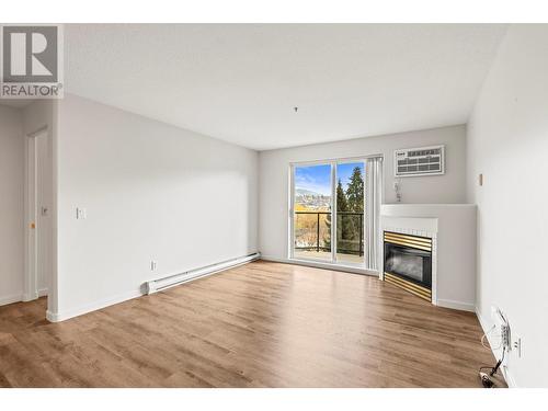 3221 Centennial Drive Unit# 210, Vernon, BC - Indoor Photo Showing Living Room With Fireplace