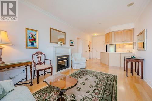 705 - 1 Lomond Drive, Toronto, ON - Indoor Photo Showing Living Room With Fireplace