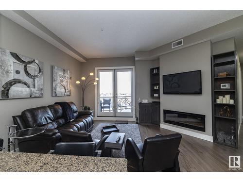 #618 11080 Ellerslie Rd Sw, Edmonton, AB - Indoor Photo Showing Living Room With Fireplace