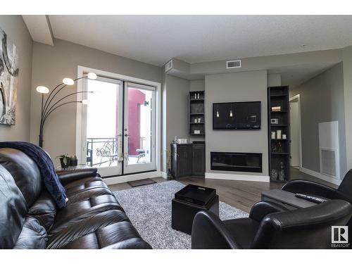 #618 11080 Ellerslie Rd Sw, Edmonton, AB - Indoor Photo Showing Living Room With Fireplace