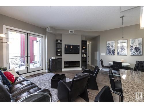 #618 11080 Ellerslie Rd Sw, Edmonton, AB - Indoor Photo Showing Living Room With Fireplace