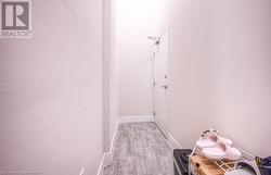 Hallway with light wood-type flooring - 