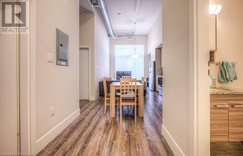 Dining space featuring dark wood-type flooring and electric panel - 253 Albert Street N Unit# 104, Waterloo, ON - Indoor