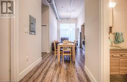 Dining space featuring dark wood-type flooring and electric panel - 