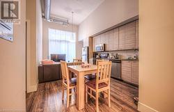 Dining room featuring sink and dark wood-type flooring - 