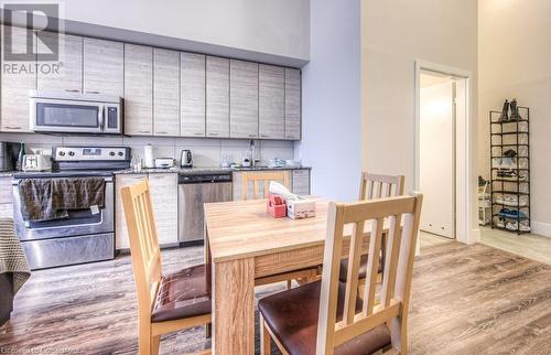 Kitchen with a towering ceiling, stainless steel appliances, light hardwood / wood-style floors, and sink - 253 Albert Street N Unit# 104, Waterloo, ON - Indoor